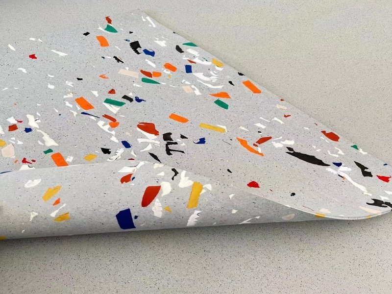 An engineering diagram showing a cross-section of rubber flooring on a concrete subfloor with force distribution lines